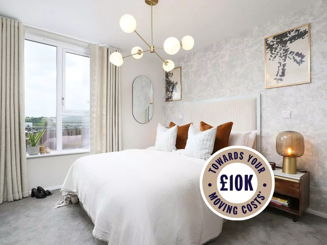 Large master bedroom, with large picture windows filling the room with natural light, showcasing a white linen queen bed with assorted white and orange pillows. Sticker overlays bedroom with 10K towards your move.