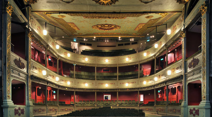 View of the empty Bristol Old Vic Theatre from the stage lit up.