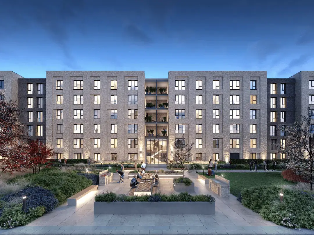 Evening shot of the stylish Dials apartments with vibrant communal garden alive with activity, surrounded by open green space.