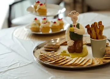 Wallace figurine placed in the centre of a cheese and crackers board. 