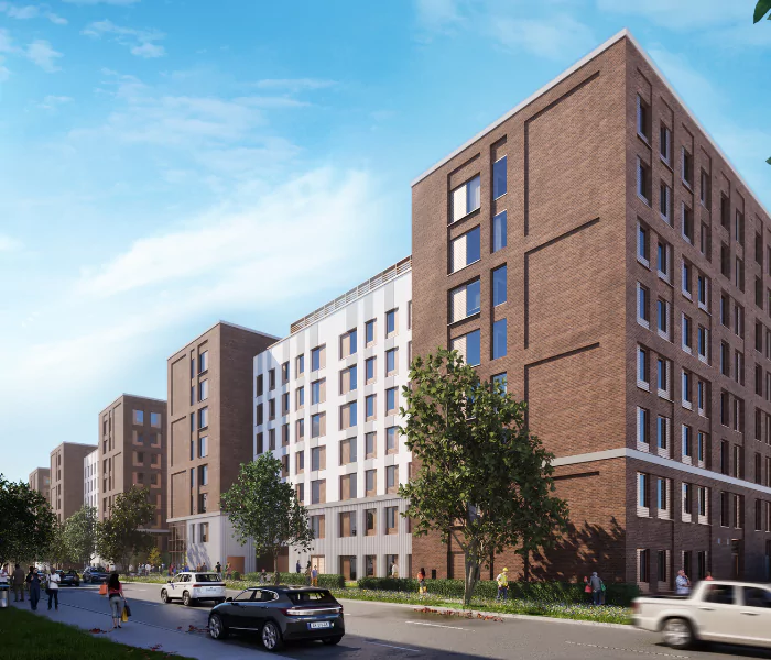treet-level view of student residences with contemporary red and white-brick exteriors, lined with trees, parked cars, and pedestrians.