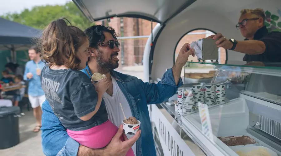 Father and daughter enhoying ice cream from Marshfield Farm at Brabazon
