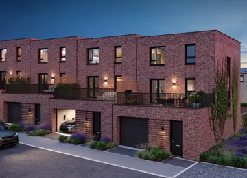 A row of terraced Buckingham homes with carport garages and balcony gardens on a landscaped street at Brabazon.