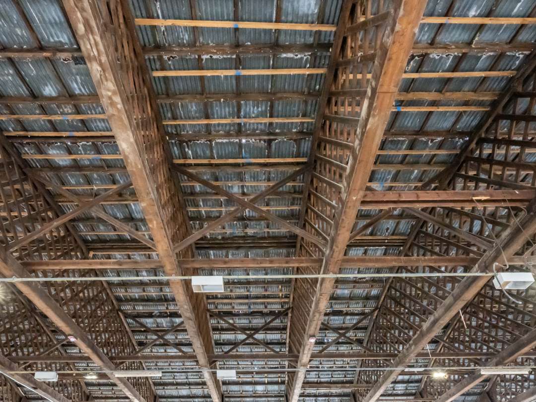 Close up of the aged roof trusses in the historic aircraft hangar 16u