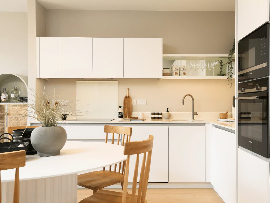 Stylish open-plan kitchen diner, featuring open shelving and integrated appliances.