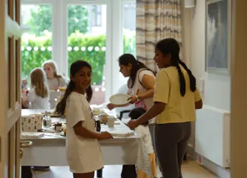 Children standing around table of snacks at Wallace & Gromit film screening hosted by Brabazon. 