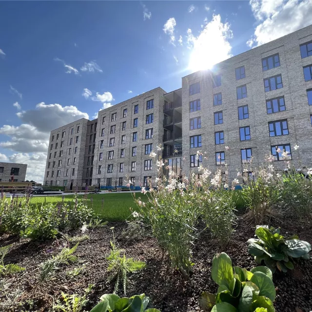 The sun peaking out behind The Dials apartment building at Brabazon in Bristol.