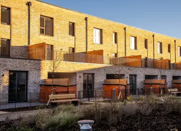 The rear exterior of The Burney three-bedroom townhouses in the sunshine.