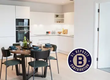 Modern kitchen and dining at The Dials with white cabinets and premium appliances.