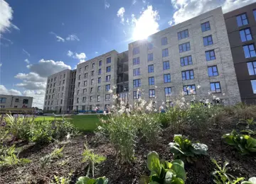 The Dials apartment building taken from the resident's communal garden on a bright sunny day.