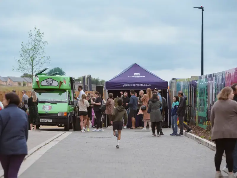 People gathering together outside ice cream truck at Brabazon, Bristol. 