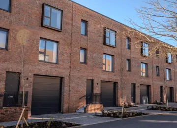 The front exterior of a row of 3-bedroom townhouses with garages at Brabazon.