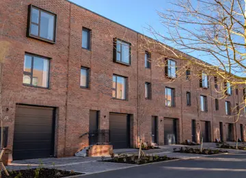 The front exterior of The Burney row of three-bedroom, red-brick terraced townhouses at Brabazon, Bristol.