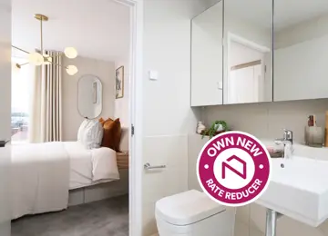 Own New Rate Reducer sticker overlaying wide angle view of primary bedroom from the ensuite. 