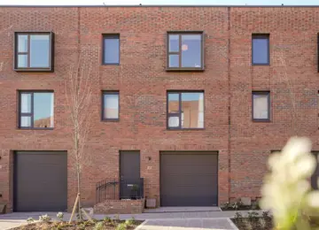 Street view of modern, 3-storey brick terrace houses at Brabazon.